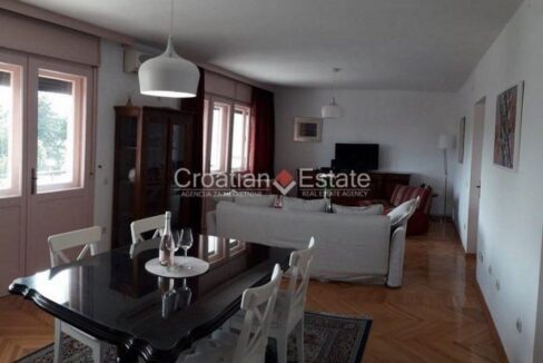 A flat for sale in Bacvice, Split, Croatia, with an open-concept room with furnished dining and living areas.