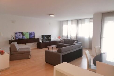An apartment for sale in Split, Croatia, with an open-concept living room with a dining area.