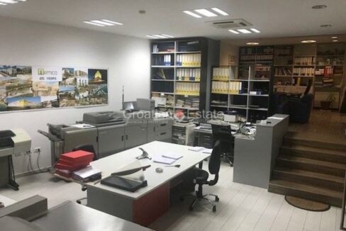 A furnished office space for sale in Split, Croatia, with a lower space and five stairs leading to an elevated space.